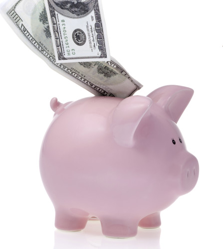 100 dollar bill in piggy bank