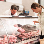 woman buying meat at the butcher shop